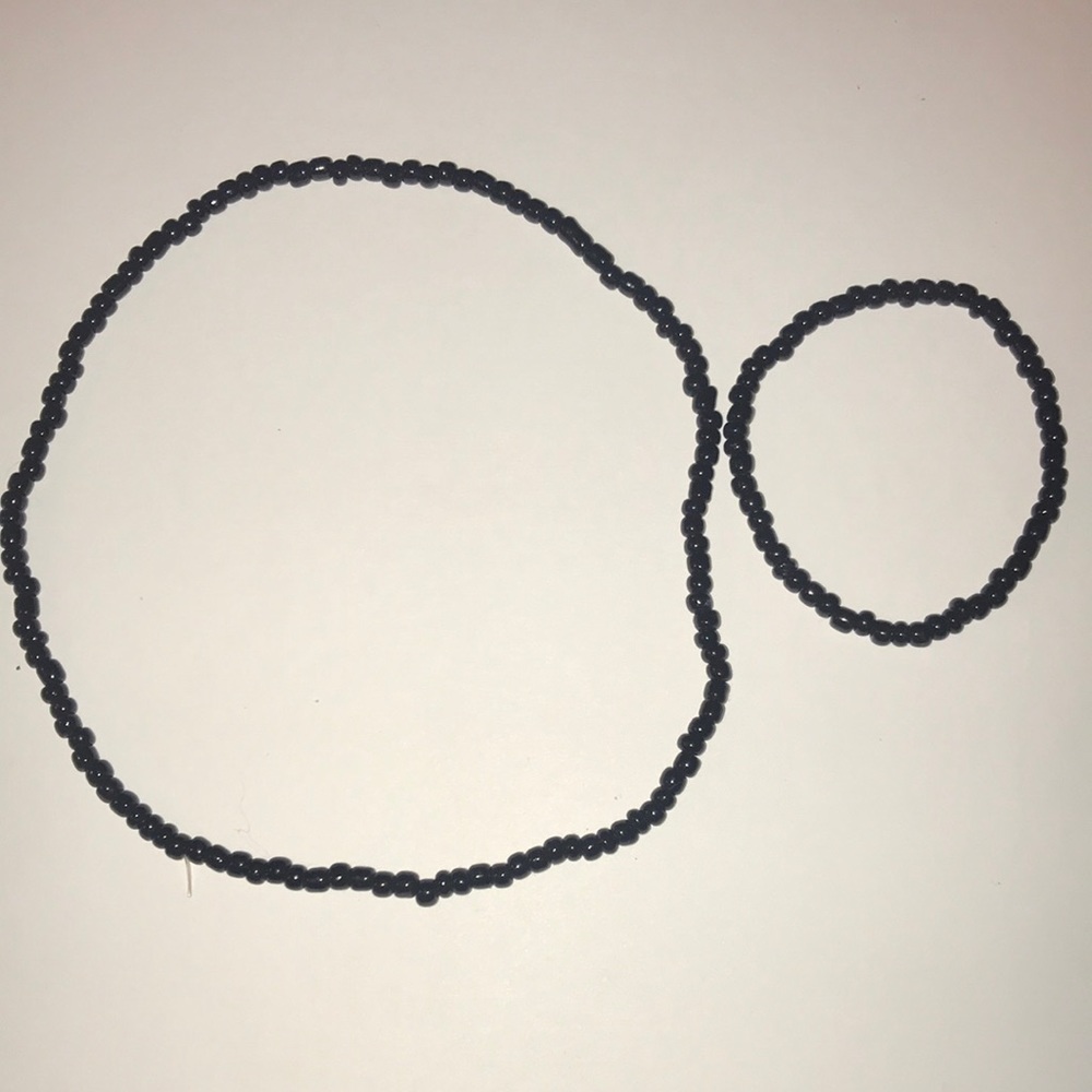 One black beaded necklace and one black beaded bracelet